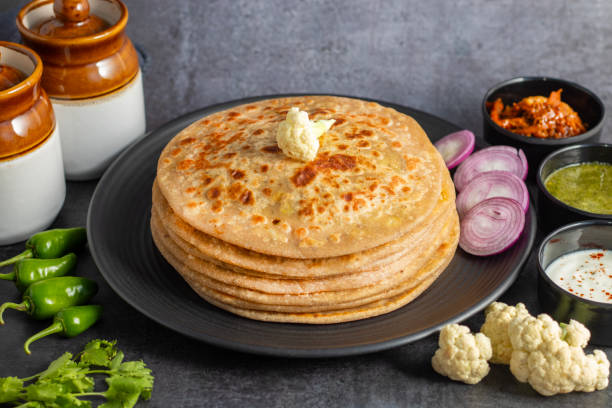 istock Gobi paratha is a stuffed Indian flatbread filled with spiced cauliflower, cooked on a griddle, often served with yogurt or pickles. 2186915215