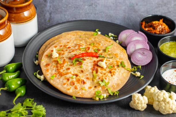istock Gobi paratha is a stuffed Indian flatbread filled with spiced cauliflower, cooked on a griddle, crispy on the outside, soft inside. Delicious! 2186915260