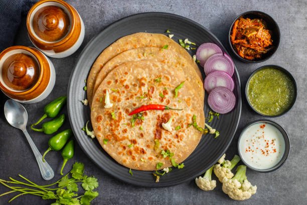 istock Gobi paratha is a stuffed Indian flatbread filled with spiced cauliflower, cooked on a griddle, often served with yogurt or pickles. 2186915261