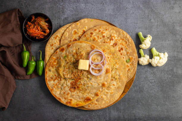 istock Gobi paratha is a stuffed Indian flatbread filled with spiced cauliflower, cooked on a griddle, often served with yogurt or pickles. 2186915333