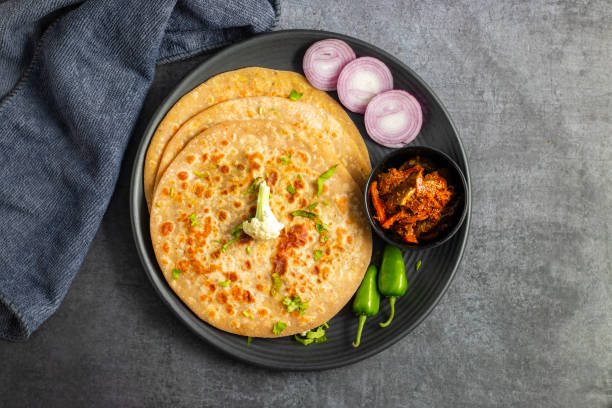 istock Gobi paratha is a stuffed Indian flatbread filled with spiced cauliflower, cooked on a griddle, often served with yogurt or pickles. 2186915366