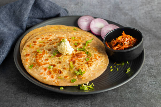 istock Gobi paratha is a stuffed Indian flatbread filled with spiced cauliflower, cooked on a griddle, often served with yogurt or pickles. 2186915369