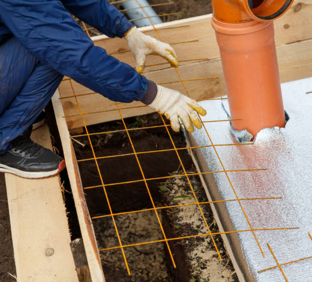 istock A man is laying down a metal grid on the ground 2186915397