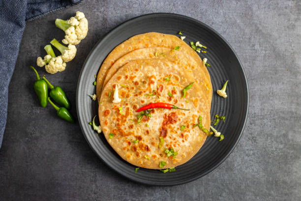 istock Gobi paratha is a traditional Indian flatbread stuffed with spiced mashed cauliflower, served hot with yogurt, pickles, or curry. Delicious and filling. 2186915409