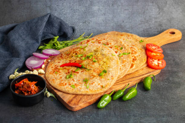 istock Gobi paratha is a traditional Indian flatbread stuffed with spiced mashed cauliflower, served hot with yogurt, pickles, or curry. Delicious and filling. 2186915414