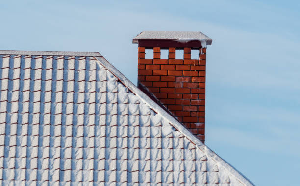 istock A chimney on a roof with snow on it 2186915489