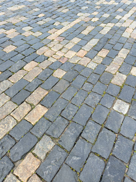 istock A brick walkway with a pattern of black and brown bricks 2186915825