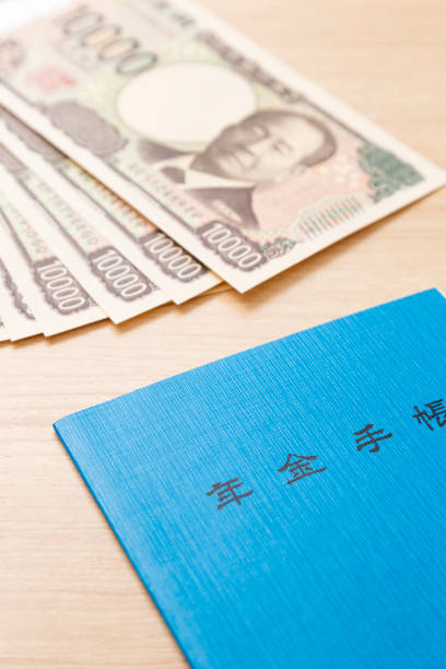 istock Pension book and money on a table 2186916780