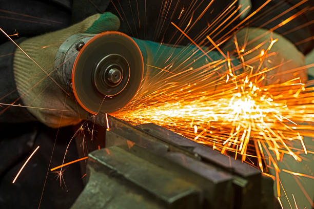 istock Workshop Concepts. Fitter in Protective Gloves and Uniform With Gringer Tool For Metal Work With Bunch of Sparks 2186917247