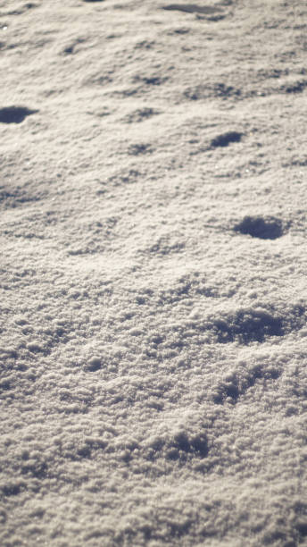istock Sunny winter background with snowy ground. Natural snow texture 2186917968
