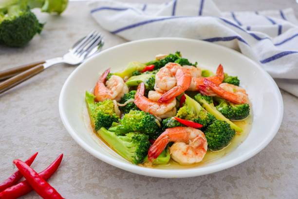 istock Homemade Stir fried broccoli with shrimp in a white ceramic plate  on cement background 2186918087