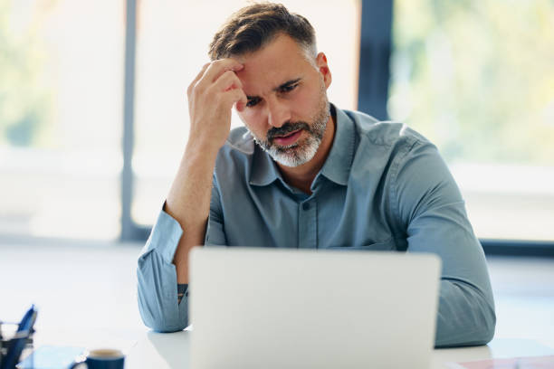 istock Thoughtful businessman working on laptop in the office. 2186918783