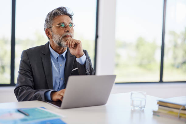 istock Thoughtful businessman working on laptop in the office. 2186918903