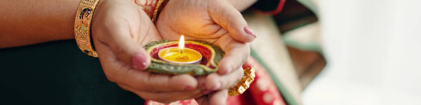 istock Holding a Traditional Diya Lamp with Burning Flame 2186922049