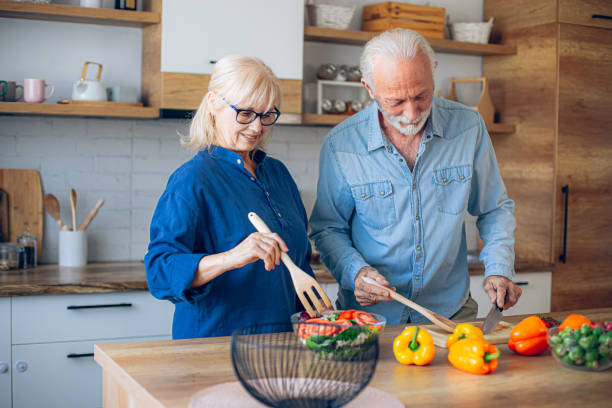 istock Senior couple preparing food in the kitchen 2186923072