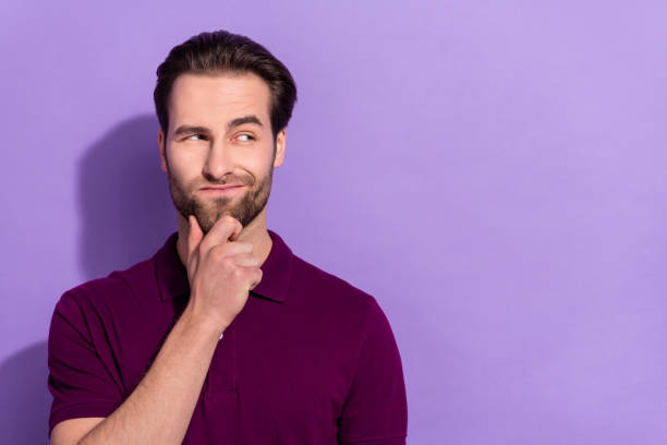 istock Portrait of handsome attractive suspicious looking man brainstorming find solution to problem isolated on violet color background 2186923154