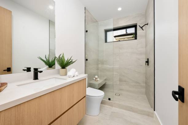 istock Modern minimalist bathroom with wood cabinetry 2186926425