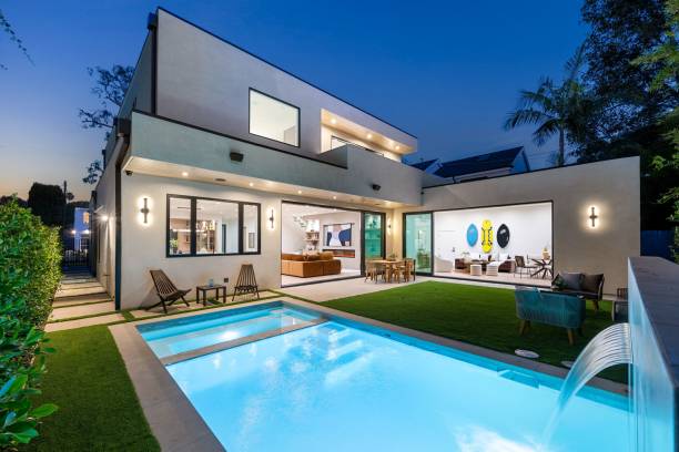 istock Modern luxury home with illuminated pool at dusk. 2186926443
