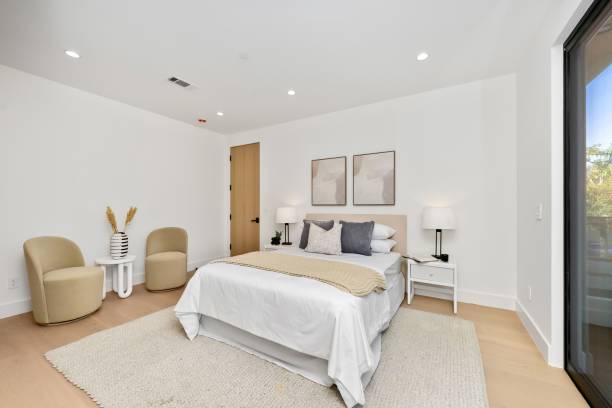 istock Modern minimalist bedroom with neutral tones and natural light. 2186926462