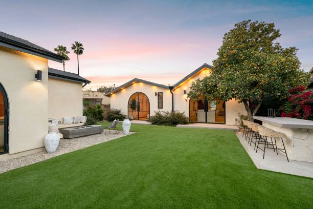 istock Modern backyard with lush lawn and seating area. 2186926482