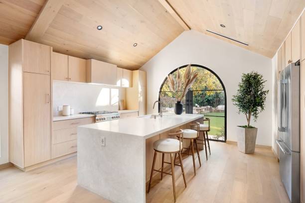 istock Modern kitchen with arch window and garden view. 2186926493