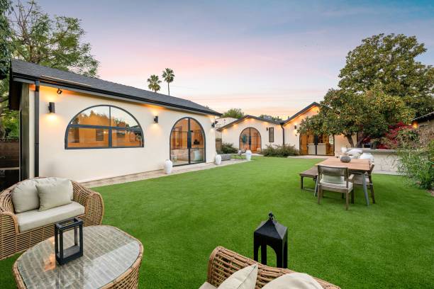 istock Modern backyard with lush lawn and elegant lighting. 2186926564