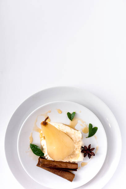 Poached pears glazed with sweet syrup on a white background