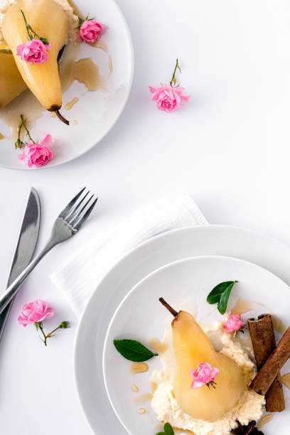 Poached pears glazed with sweet syrup on a white background