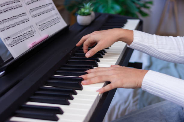 istock Young pianist playing a digital piano at home 2186927687