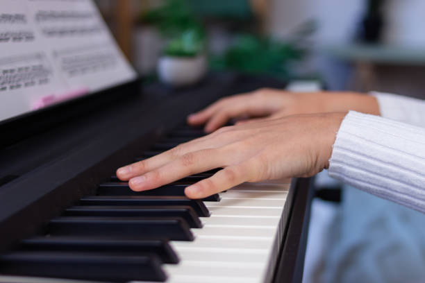 istock Young musician playing piano with sheet music 2186928111