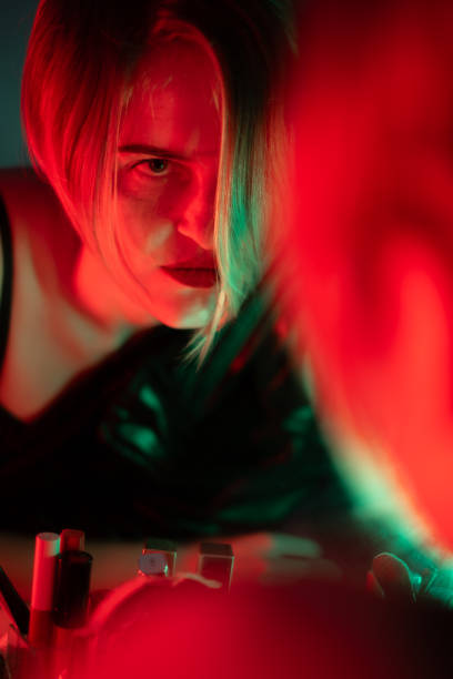 istock Blonde Woman is Looking at Herself in the Mirror 2186929121
