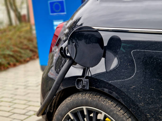 istock charging batteries in car can be problem in cold and snow. cables between vehicles can cause problems in parking lot when shoveling snow or tripping pedestrian. children should not touch  high voltage 2186929129