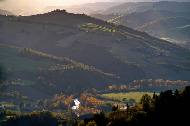 istock Montefeltro hilly landscape with fields in golden hour against cloudy sky 2186931360