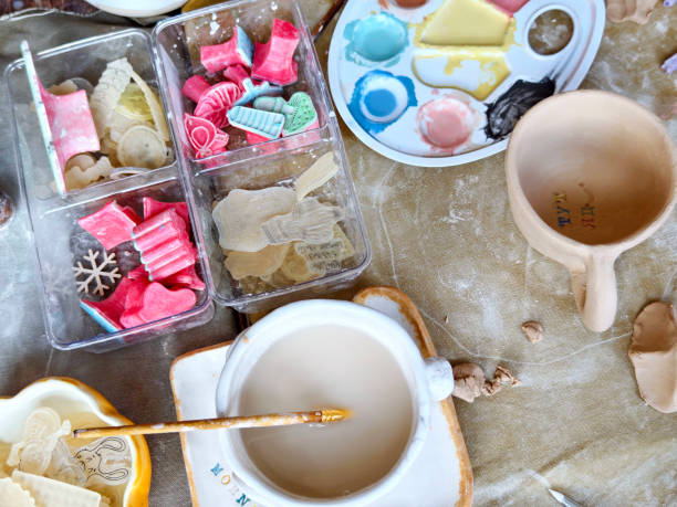 istock Workshop for kids. Children learning how to use clay for making dishes. 2186931399
