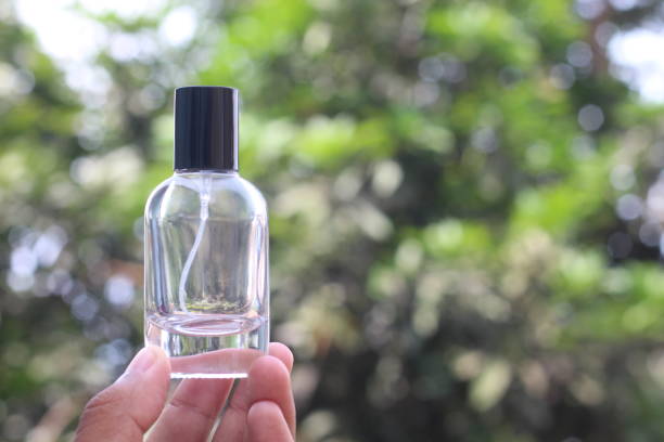 istock a man's hand eleganthy holds a glass perfume bottle 2186932046