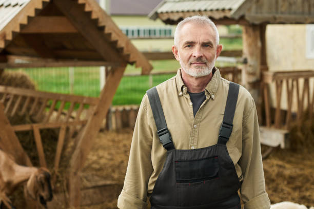 istock Serious senior male farmer in overalls 2186932279