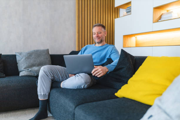 istock Man Relaxing with Laptop on Comfortable Sofa at Home 2186934460