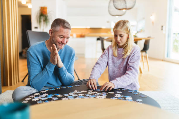 istock Father and Daughter Bonding Over Puzzle in Cozy Home 2186934568