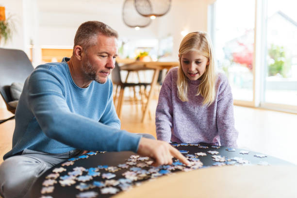 istock Father and Daughter Bonding Over Puzzle at Home 2186934592