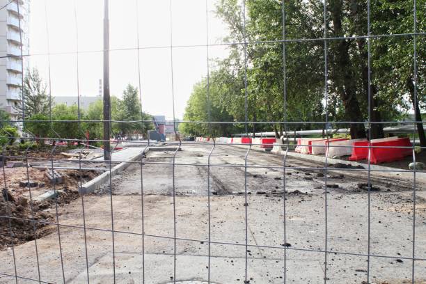 istock A construction site with fenced-off road undergoing repairs. Urban development and progress. A city street closed for construction, with barriers and excavated pavement. Ongoing development and change 2186935361