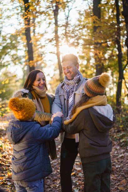 istock A happy family joins hands together while standing in the forest 2186935861