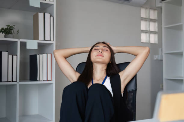 istock Stressed Business Woman at Work in Modern Office Environment Experiencing Overwhelm and Fatigue 2186936317