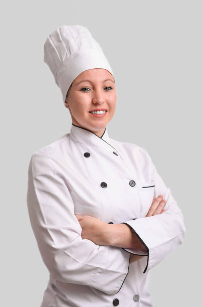 istock Confident female chef smiling with arms crossed on gray background 2186941232
