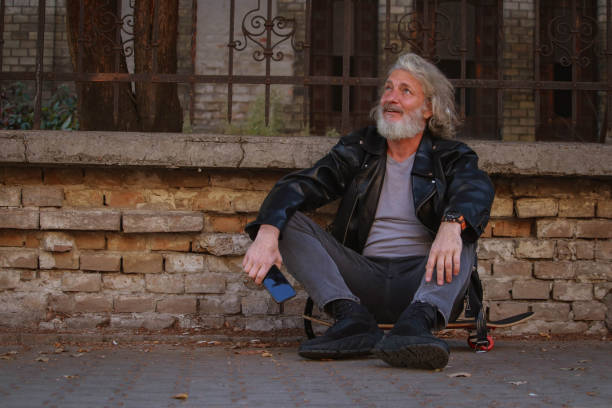 Thai senior man sitting on a bench in park