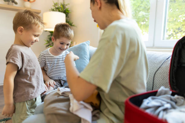 istock Mom and her toddlers having fun while packing 2186943076