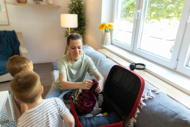 istock Mom and her toddlers having fun while packing 2186943085