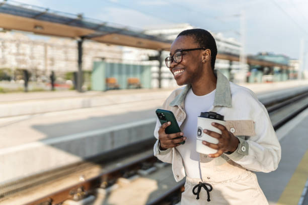 istock Young woman waiting for the train. 2186943099