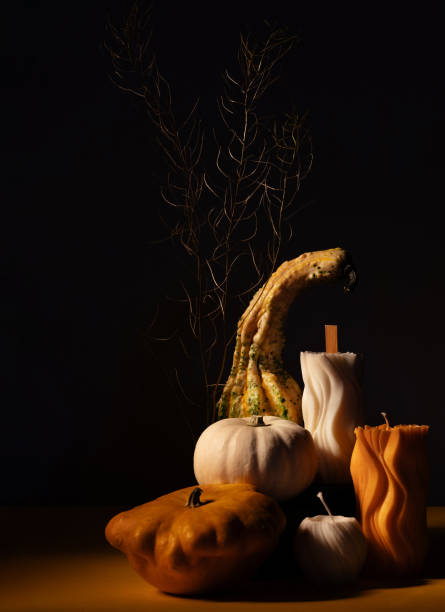 still life with decorative pumpkins and candles