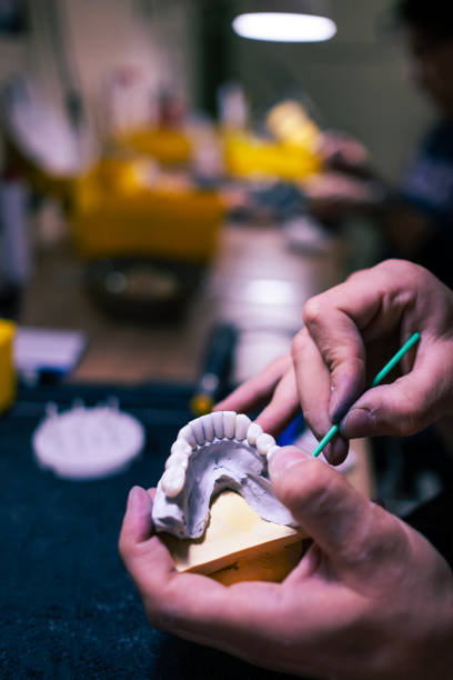 istock a dental technician works on a new model of teeth 2186946166