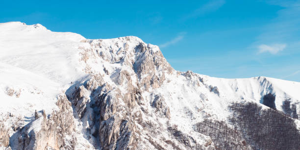 istock Majestic Snow-Covered Mountain Range Under Clear Blue Sky 2186946691